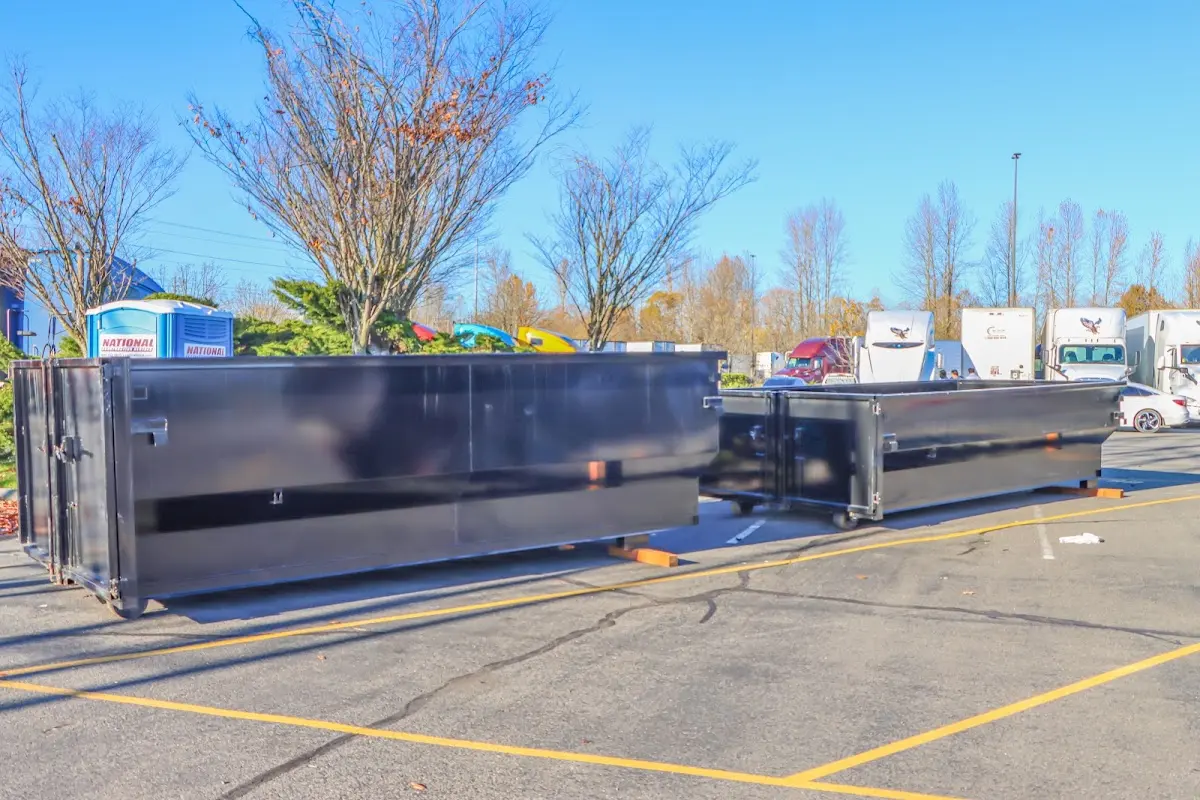 Professional dumpster rental service with roll-off container on residential driveway in Glenville